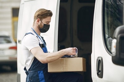 man-by-the-truck-guy-in-delivery-uniform-man-in-medical-maskman-by-the-truck-guy-in-delivery-uniform-man-in-medical-mask-coronavirus-concept-min